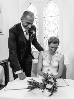 Photograph of Bride and Groom Signing Register